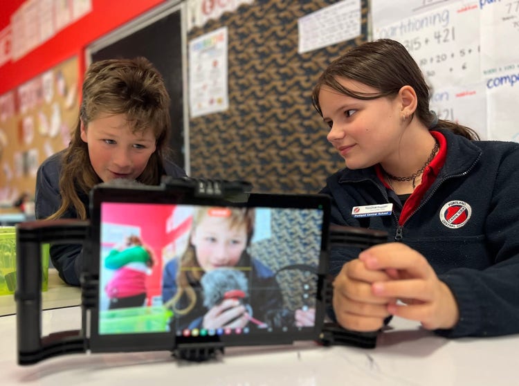 Students filming with iPad in classroom