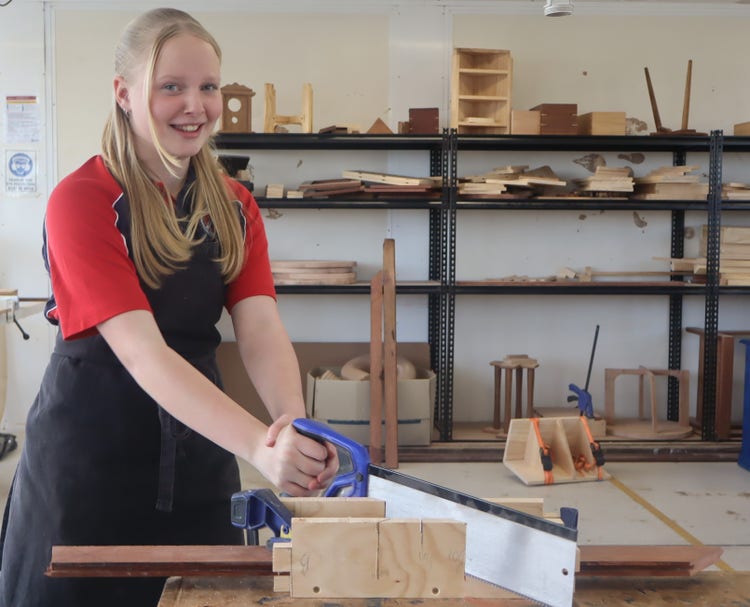 Student using saw in timber workshop