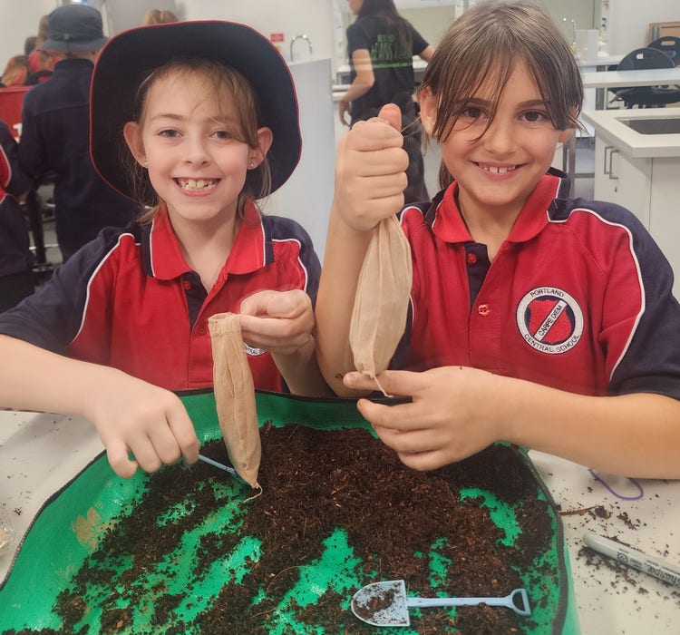 Two students working with soil in Science