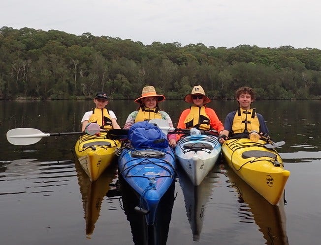 4 students in kayaks at Duke of Edinburgh camp