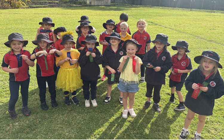 Infants students with winning ribbons