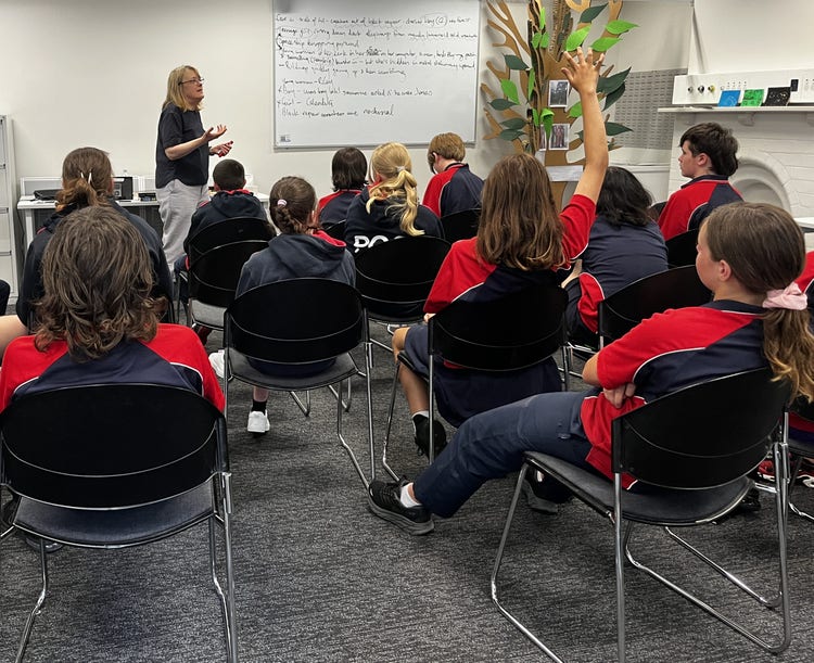 Students asking questions at writing workshop